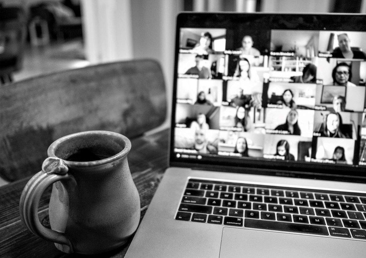 Laptop on desk showing Zoom meeting