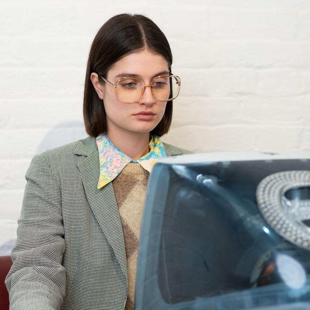 Woman Using retro Imac computer wearing Aphrodite Blue Light Glasses by Odysee Eyewear